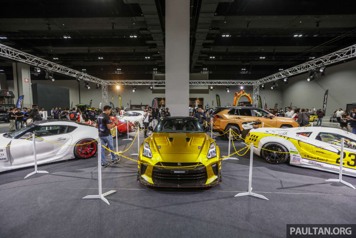 Gold Nissan GT-R and modified cars on the show floor at Tokyo Auto Salon Kuala Lumpur 2023.